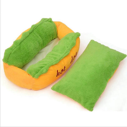 Hot dog shaped pet bed with green plush insert and orange fabric base; matching green pad