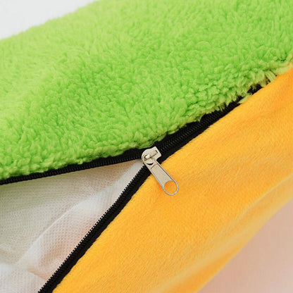Hot dog shaped pet bed detail with black zipper on orange base and green plush top