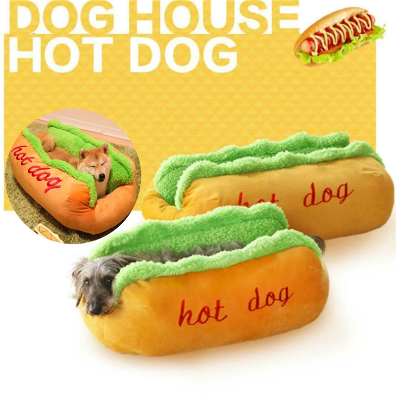 Hot dog-shaped pet bed, orange cushion with green bolster and red 'hot dog' embroidery.