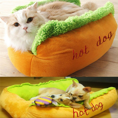 Hot dog shaped pet bed in orange with green plush edge; cat and dog resting
