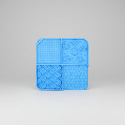 Blue silicone slow feeder lick mat with dotted suction, paw-bubble, and honeycomb textures