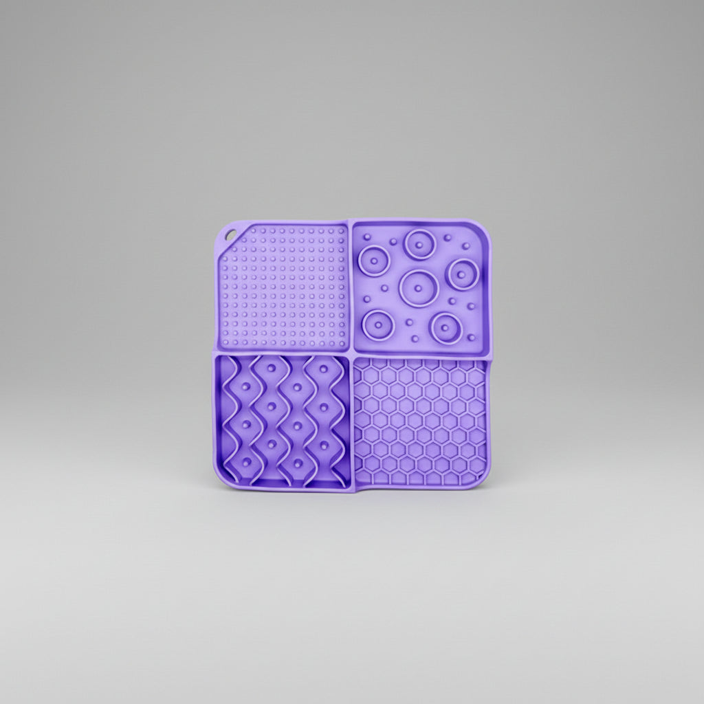 Purple silicone slow feeder lick mat with dotted, paw-bubble, diamond, and hexagon textures