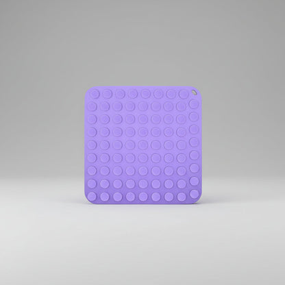 Purple silicone slow feeder lick mat with dotted suction pattern on one side