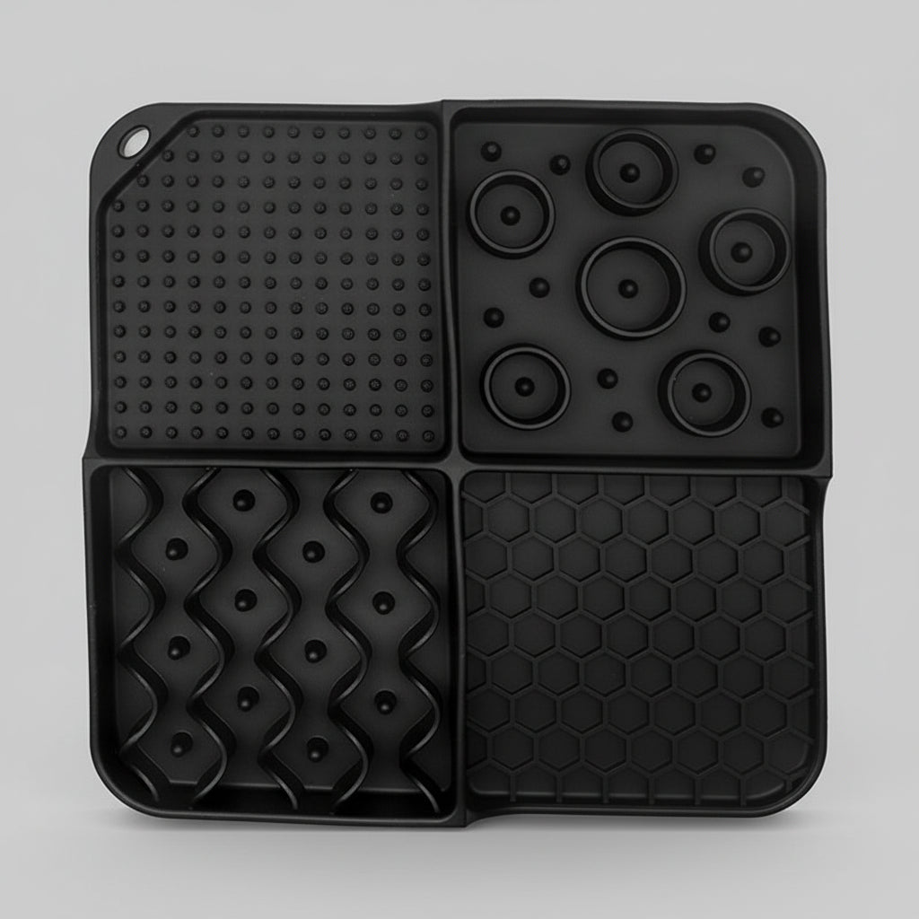 Black silicone slow feeder lick mat with dot panel, paw-disk bumps, and hexagon grid