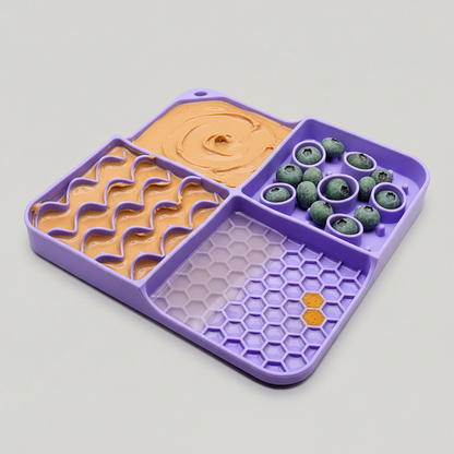 Purple silicone slow feeder lick mat with orange swirl and hex textured sections
