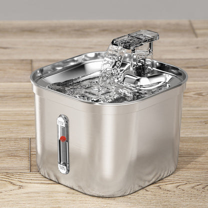 Stainless steel pet water fountain on a wooden surface with visible recirculating water