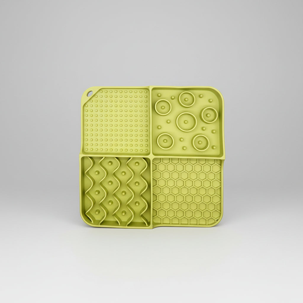 Light green silicone slow feeder lick mat with dotted suction, circle bumps, and hexagon grid