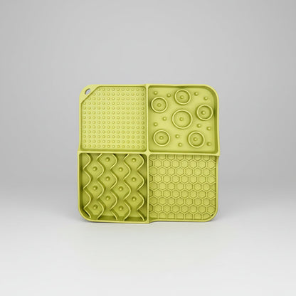 Light green silicone slow feeder lick mat with dotted suction, circle bumps, and hexagon grid