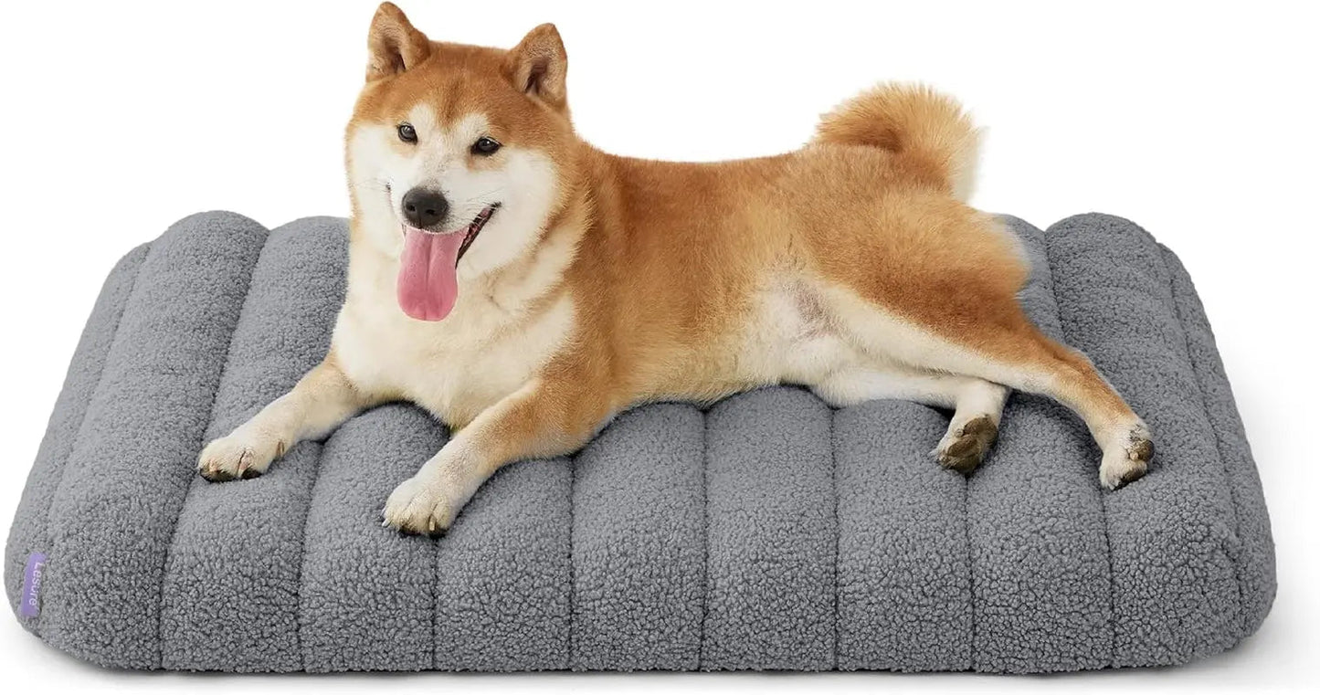 Orthopedic dog bed, dark gray plush with rounded bolsters and vertical quilt lines