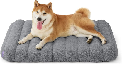 Orthopedic dog bed, dark gray plush with rounded bolsters and vertical quilt lines