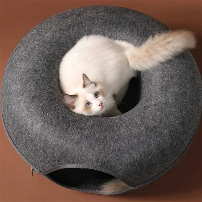 Fluffy cat nestled in cozy gray donut-shaped cat bed, perfect for pet comfort and relaxation