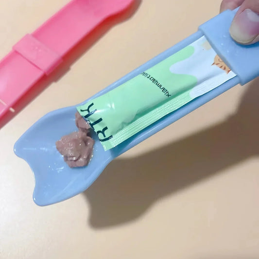 Blue squeeze cat treat spoon with wide licking tip