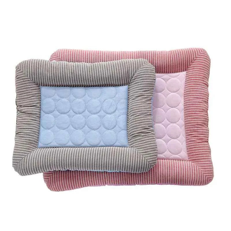 Pink cooling pet mat with light blue dotted insert and gray-striped bolster sides.