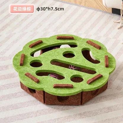 Interactive cat puzzle scratch toy with green felt top, brown base, and multiple paw-shaped holes