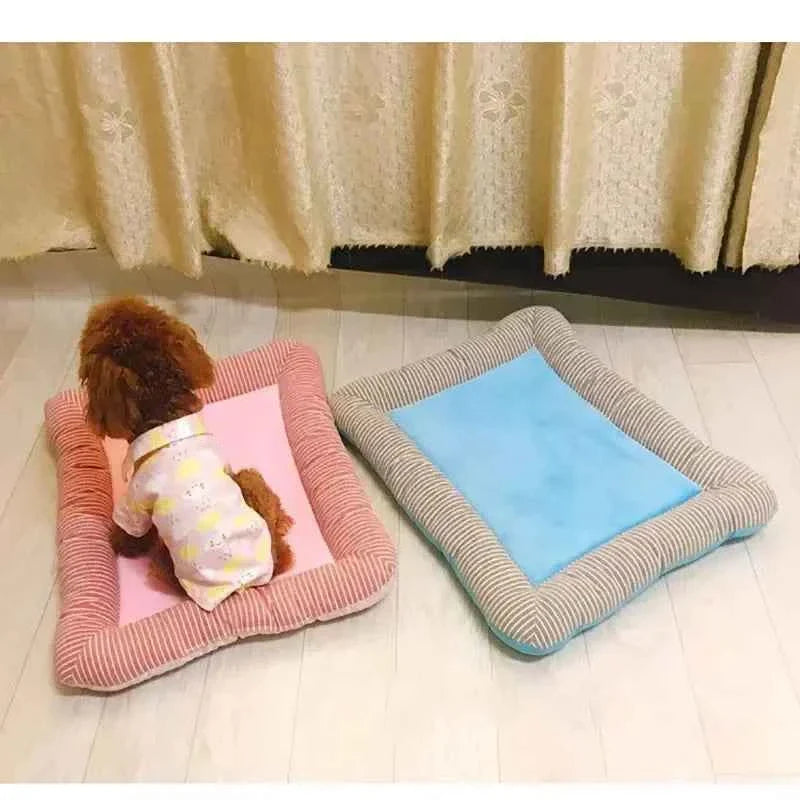 Two cooling pet mats: pink and light blue, each with striped fabric edges.