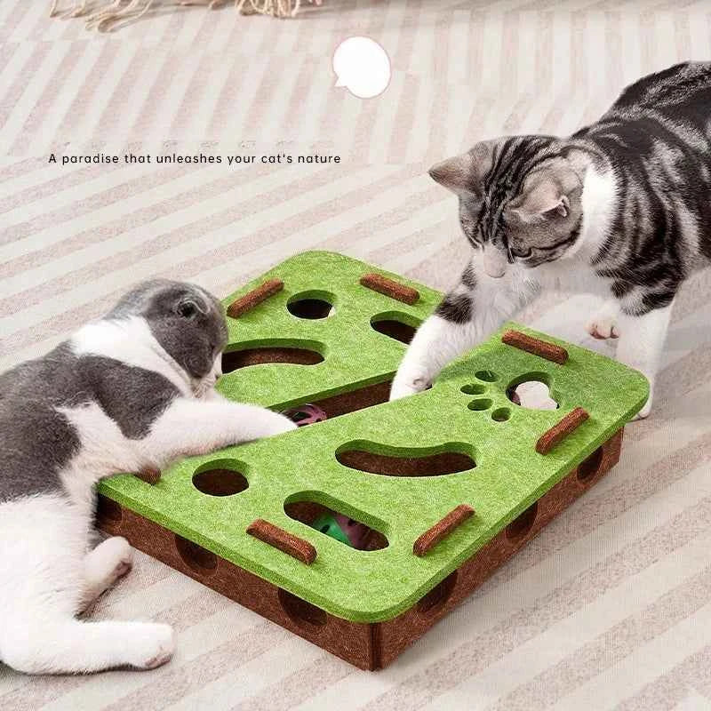 Interactive cat puzzle scratch toy with green felt top and brown base, with holes and pegs