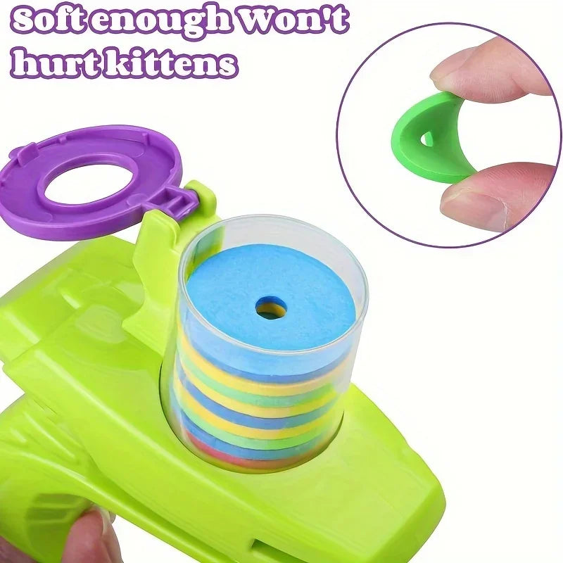 Close-up of green and purple disc launcher toy with rainbow soft discs