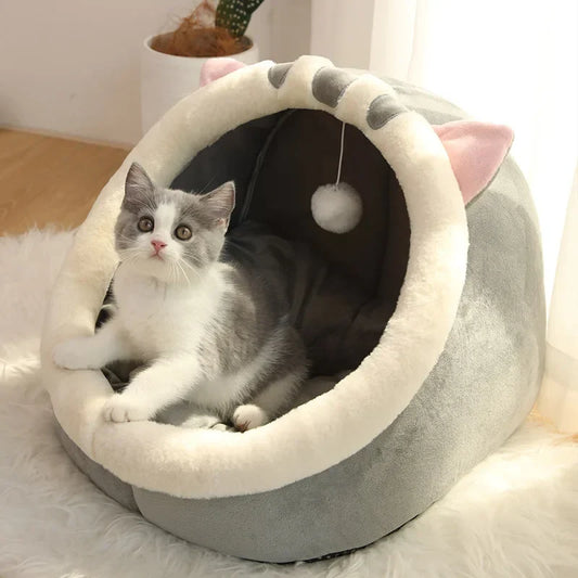 Foldable plush cat cave bed with cream rim, cat-ear hood, and hanging pom-pom
