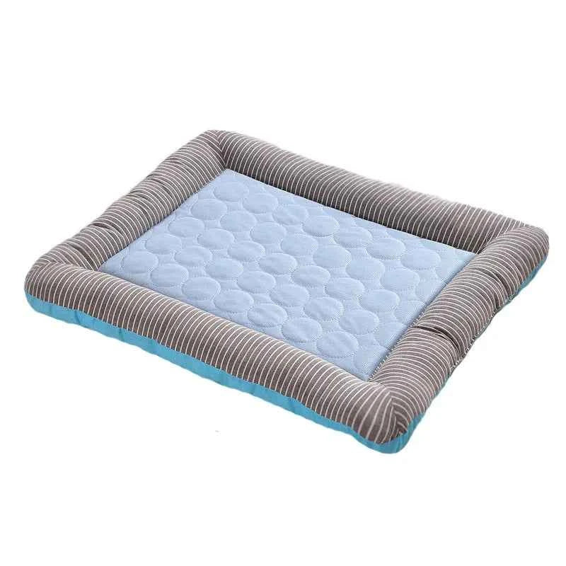 Blue cooling pet mat with light blue dotted surface and gray-striped raised frame.