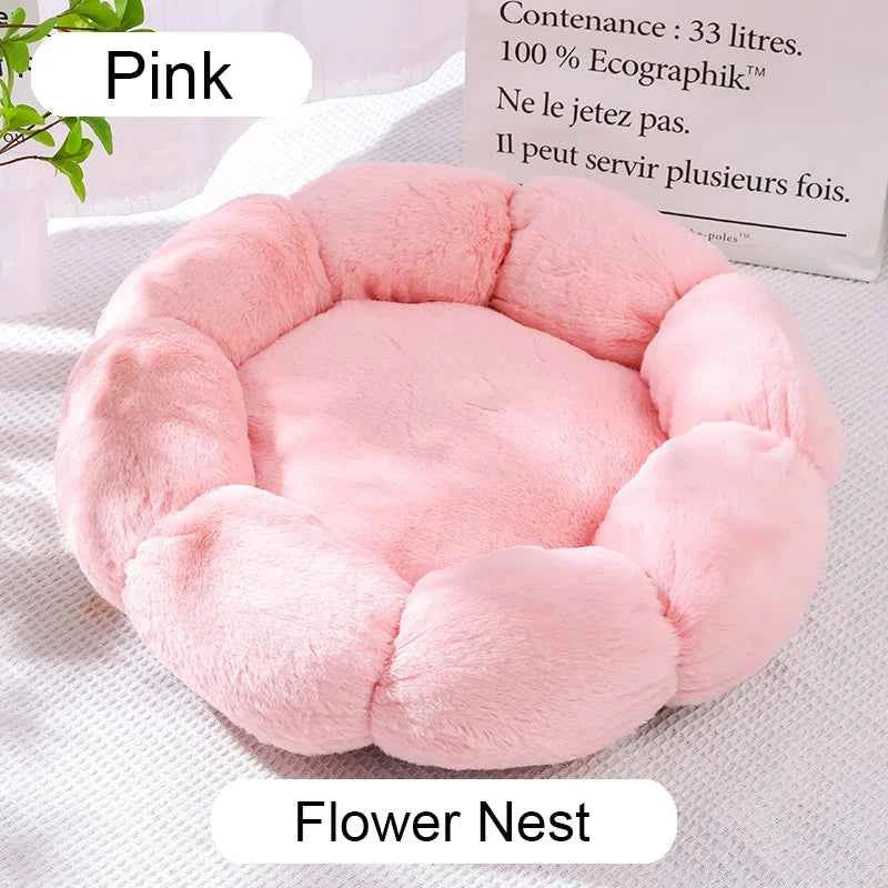 Pink round plush pet bed with cushioned center and raised donut-style edges