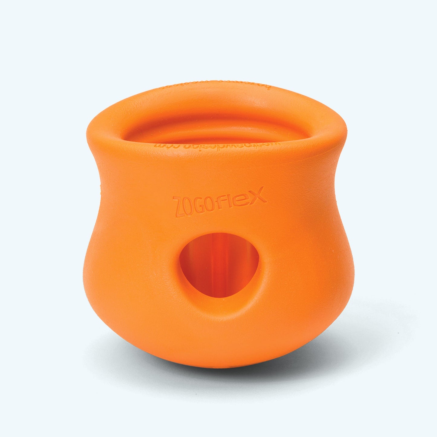 Orange silicone treat dispenser with circular hole opening on the front