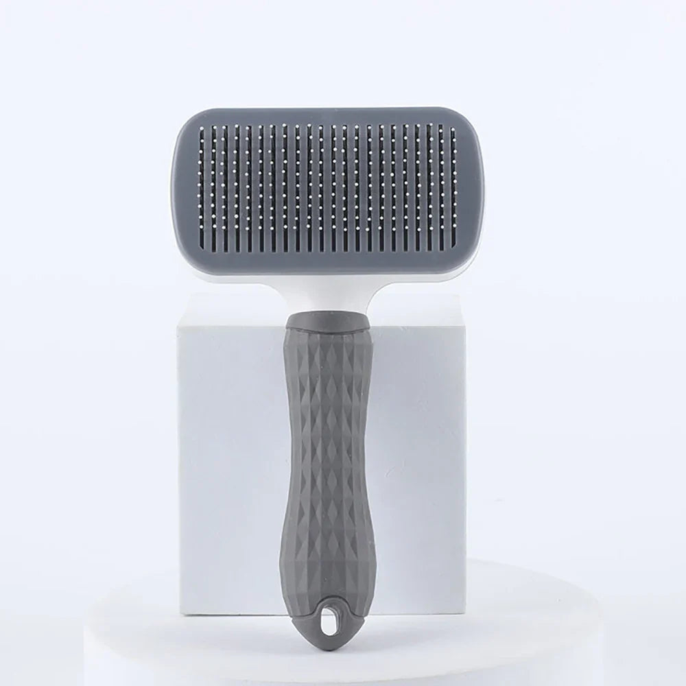 Gray pet deshedding brush with round needle pad and textured grip handle