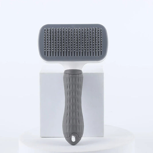 Gray pet deshedding brush with round needle pad and textured grip handle