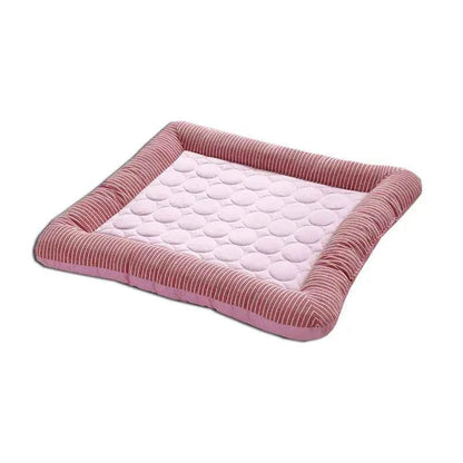 Pink cooling pet mat with pale dotted surface and gray-striped fabric border.