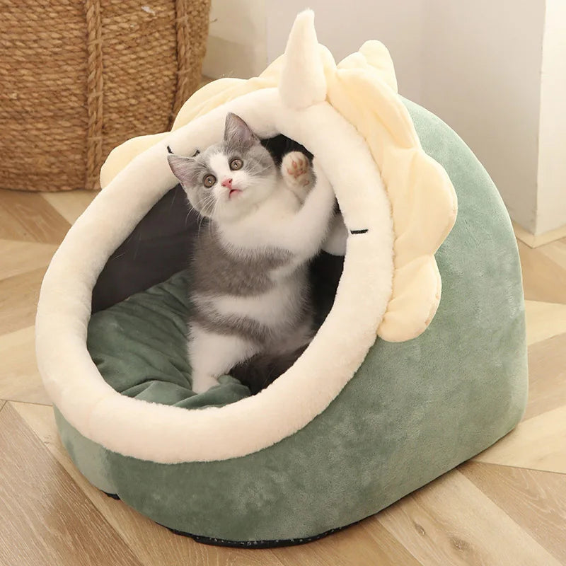 Plush cat cave bed in sage green with cream cat-ear hood and cozy interior cushion