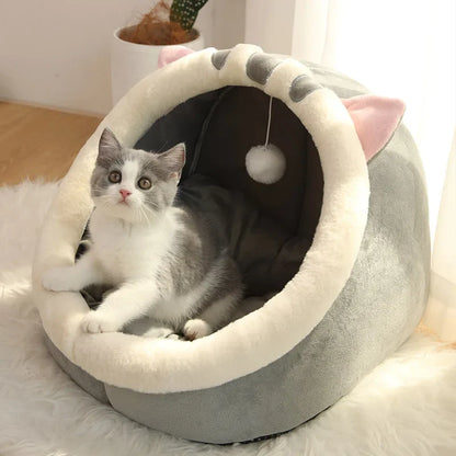 Gray and cream plush cat cave bed with striped arch and pom-pom