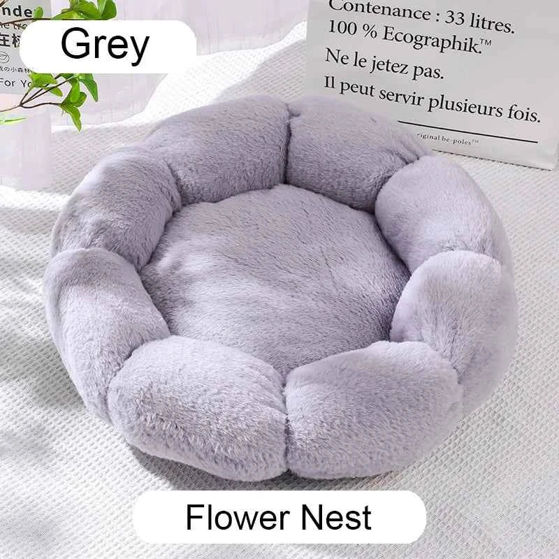 Grey round plush pet bed with cushioned center and raised donut-style edges