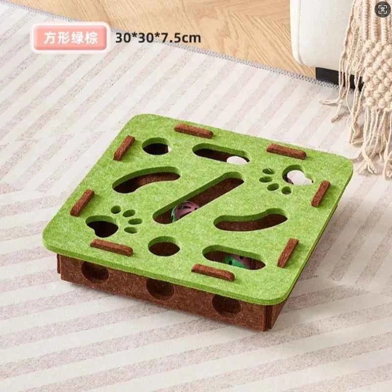 Interactive cat puzzle scratch toy with green felt top, paw cutouts, and brown wood edges