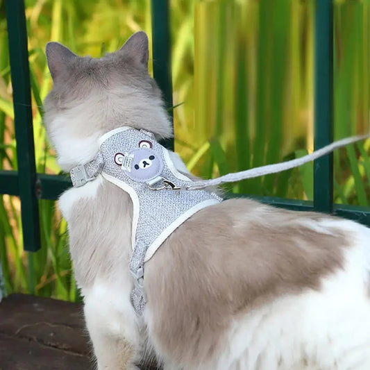 Light blue adjustable pet harness vest with bear patch and leash attachment ring