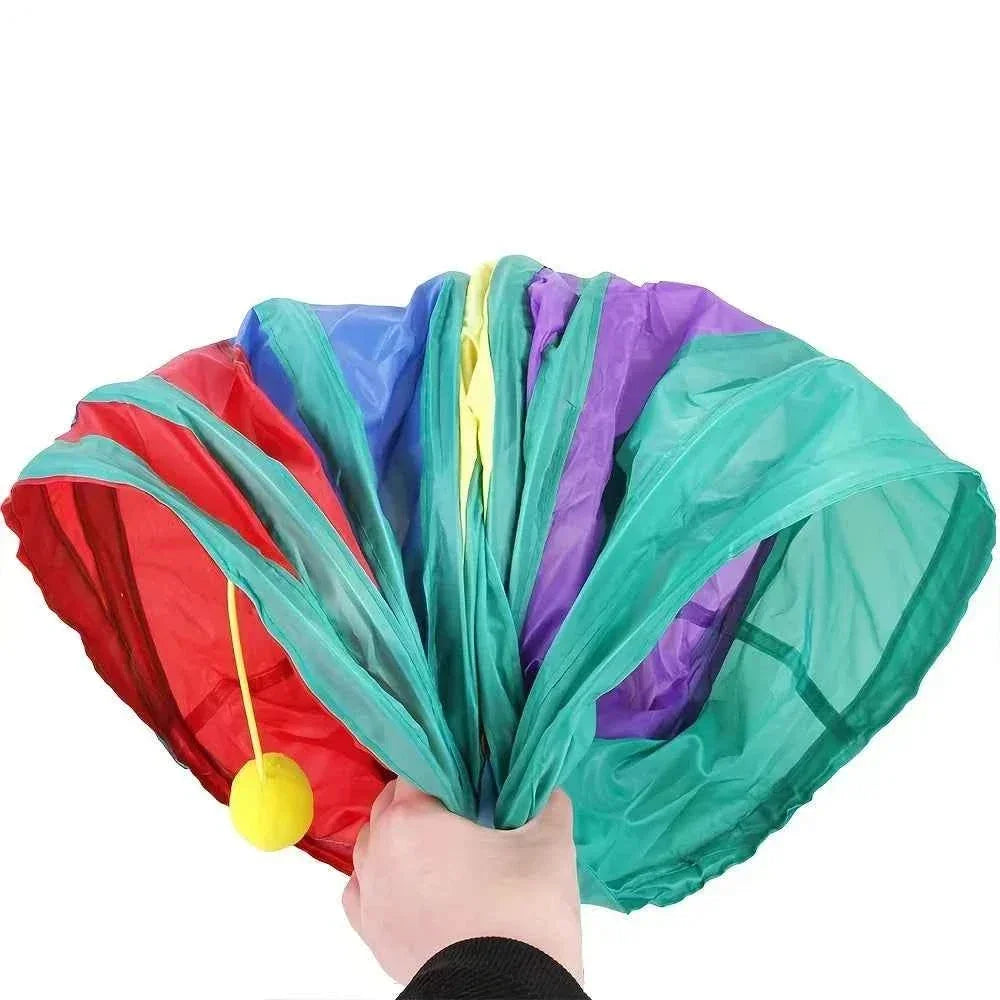 Folded colorful WTN Essentials breathable cat tunnel toy with yellow ball attachment
