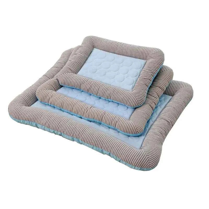 Cooling pet mat with light blue dotted top and gray-striped fabric sides.