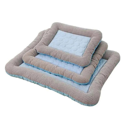 Cooling pet mat with light blue dotted top and gray-striped fabric sides.