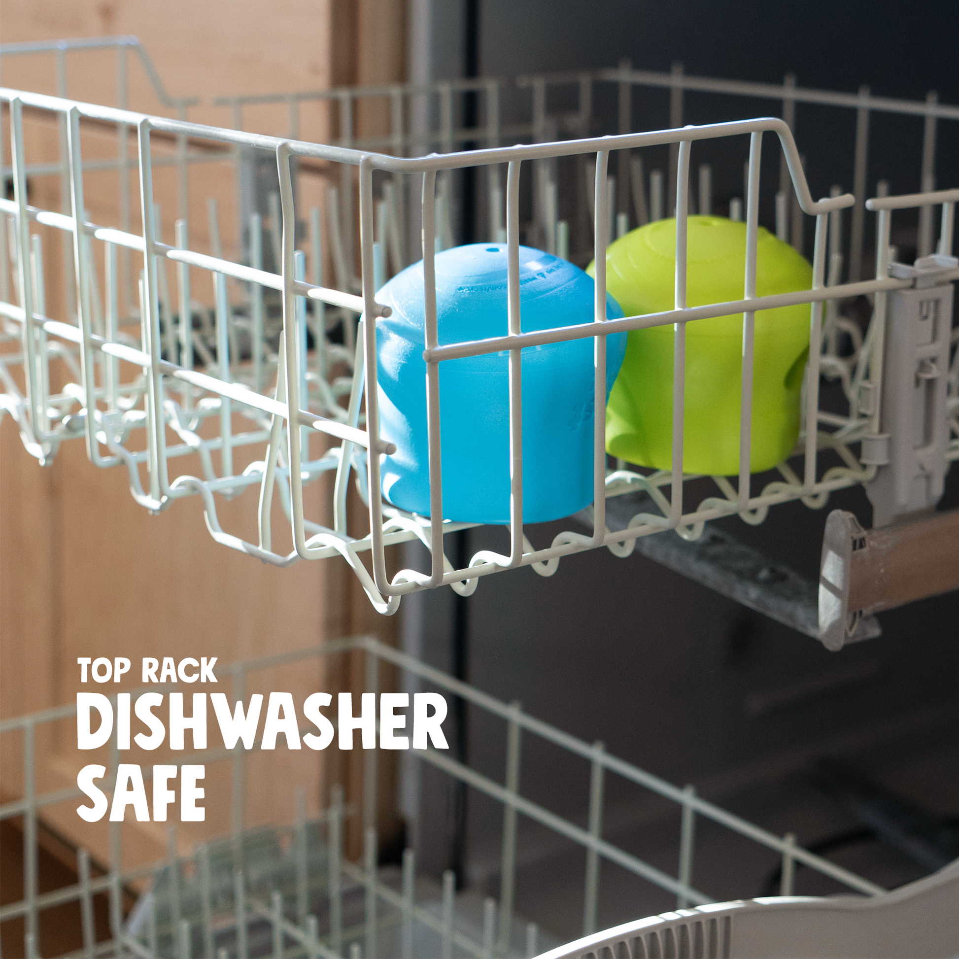 Blue and green silicone dog treat toy bowls in a dishwasher rack