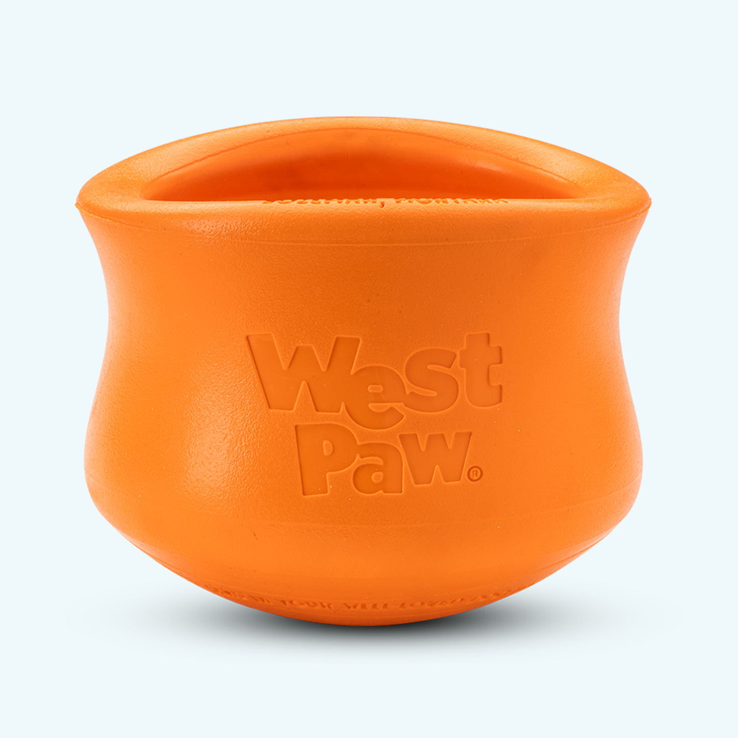 Orange silicone dog treat toy bowl with embossed West Paw logo