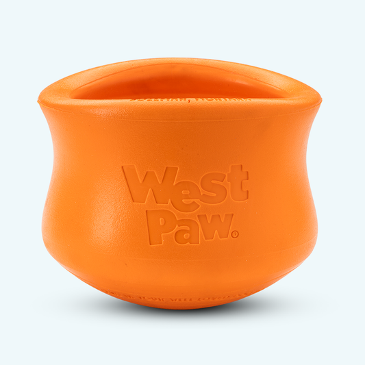 Orange silicone dog treat toy bowl with embossed West Paw logo