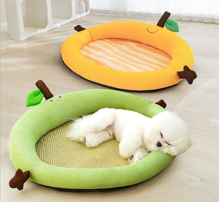 Cute white dog napping in green apple-shaped pet bed, yellow banana bed nearby, cozy indoor setting