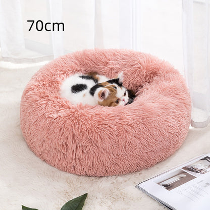 70 cm round pet bed, dusty pink plush with a small cat sleeping inside.