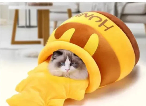 Cat nestled in cozy honey pot-shaped pet bed, perfect for pampered feline comfort and play