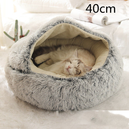 Grey plush oval pet bed viewed from above, open interior with soft lining