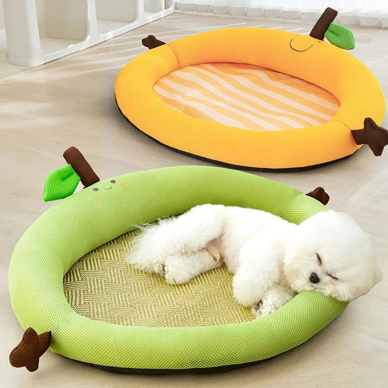 Cute white dog sleeping in green apple-shaped pet bed with striped mat, banana design nearby
