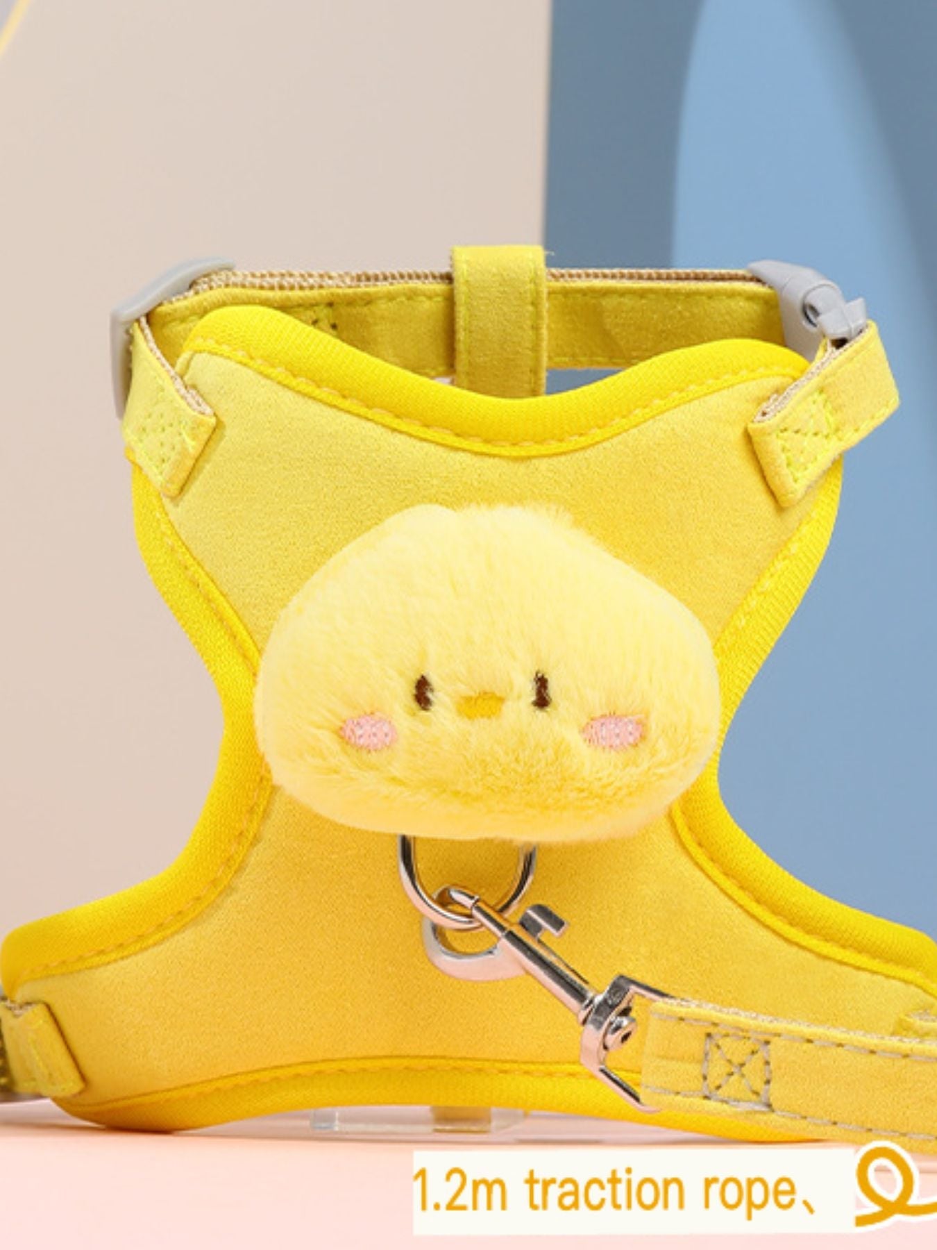 Yellow pet harness with plush animal head and metal D-ring; shows 1.2m traction rope