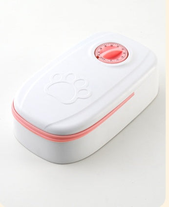 Automatic pet feeder with pink control dial on white body, gray base