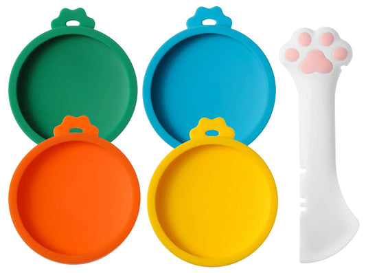 Four silicone cat food can lids in green, blue, orange, and yellow with paw spoon