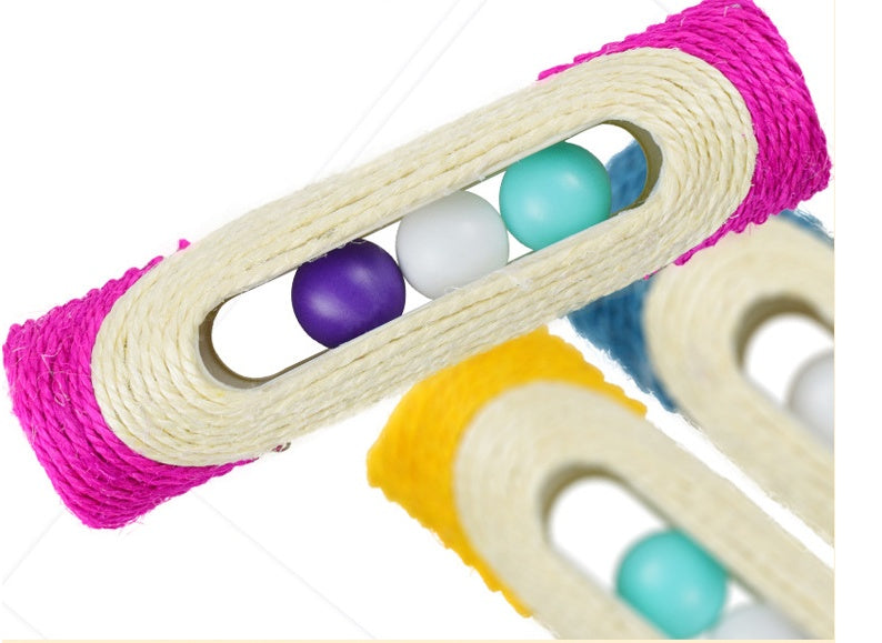 Sisal drum cat toy with purple outer ring and beige tunnels holding teal and white balls