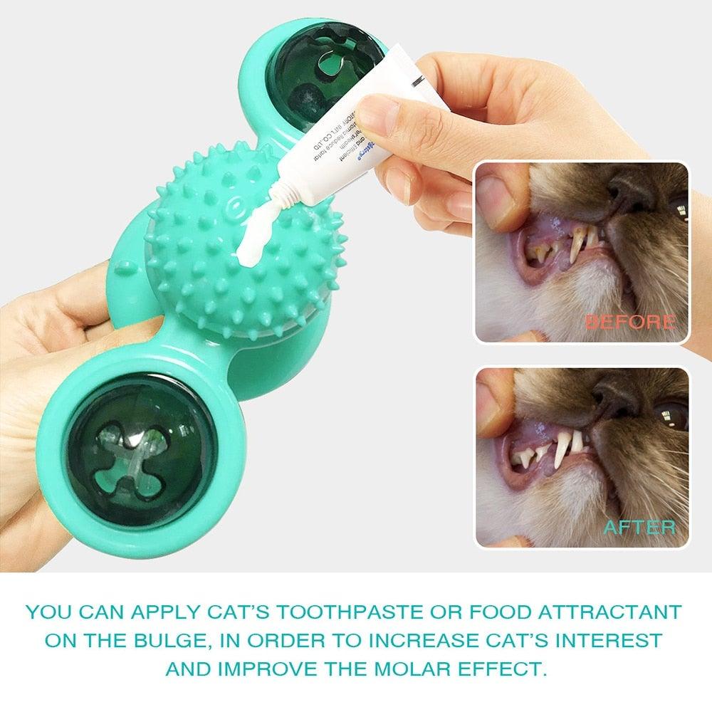 Cat windmill toy with teal spiky pad, domed side cups, and removable top hole