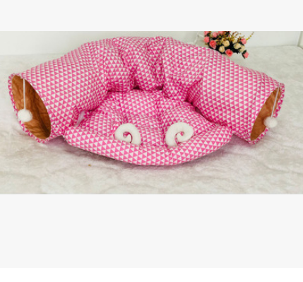 Pink geometric fabric cat tunnel bed with padded round opening and inner cushion